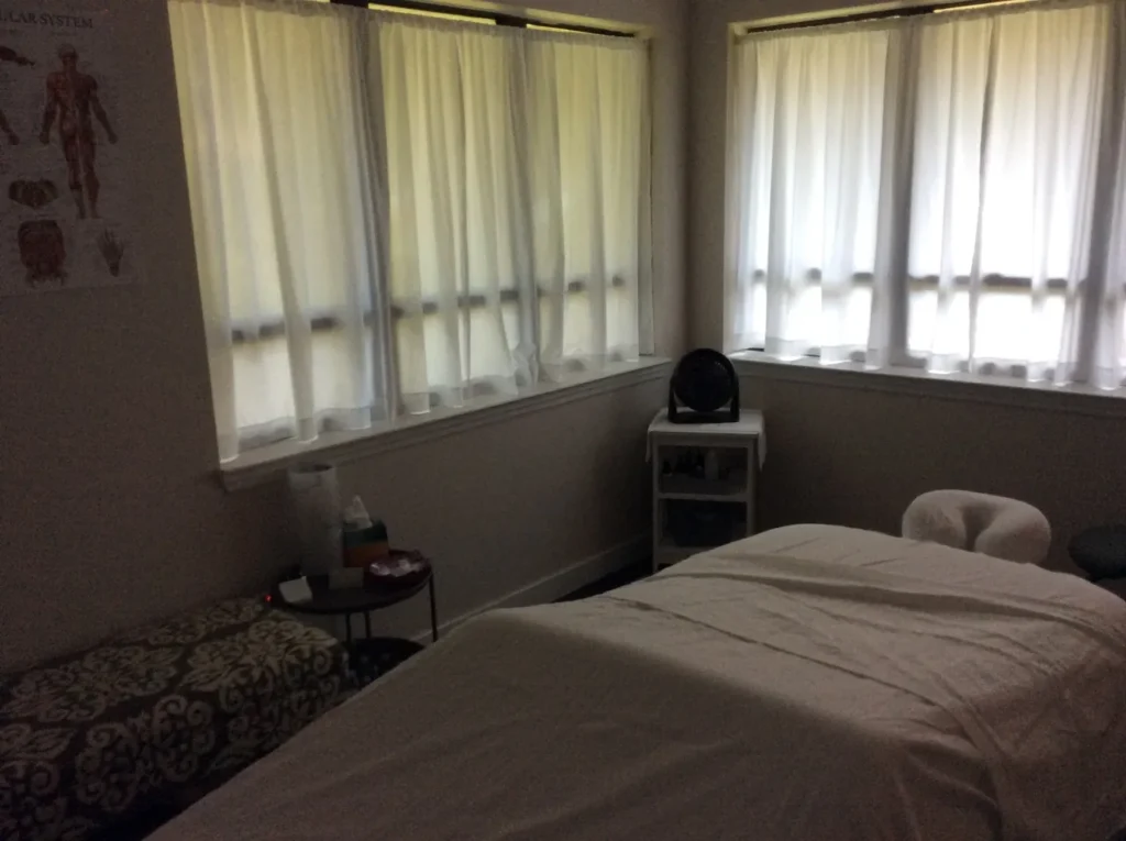 A serene treatment room at Life Touch Massage and Lymphatic Care with professional equipment, soft lighting representing the specialized care environment.